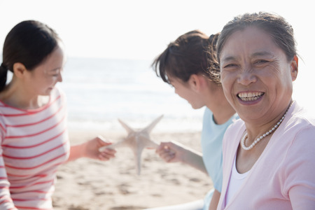 Portrait of multi- generational family on the beach, starfishの写真素材