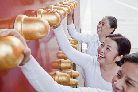 Group of mature women standing next to the traditional Chinese doorの写真素材