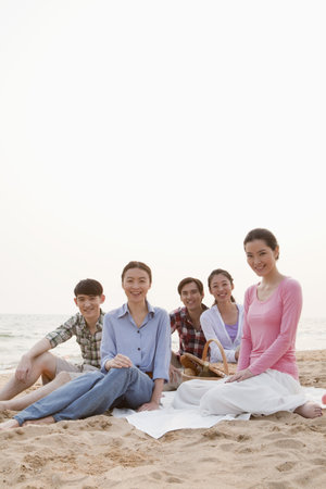 Group of Friends Having a Picnic by the Seaの写真素材