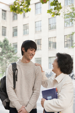 Student talking with his professor の写真素材