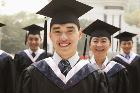 Young Graduates in Cap and Gownの写真素材