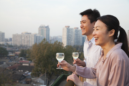 Couple Looking Out Over Cityscapeの写真素材