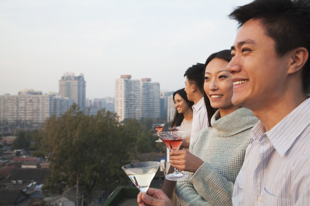 Friends Looking Out Over Cityscapeの写真素材