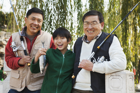 Multi-generational men fishing portraitの写真素材