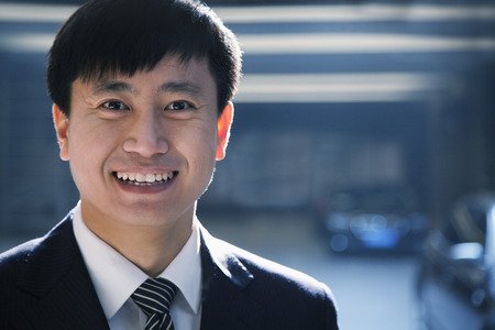 Portrait of businessman in a parking garageの写真素材