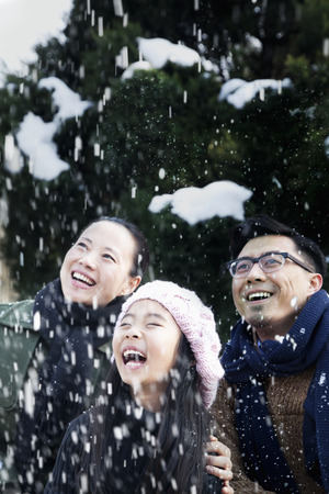 Family enjoying a snowy dayの写真素材