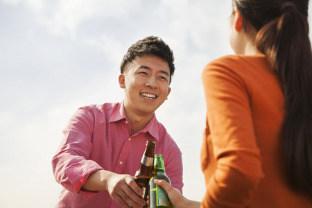 Friends Toasting Each Other on a Rooftopの写真素材