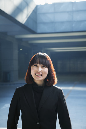 Portrait of businesswoman outdoors in a parking garageの写真素材