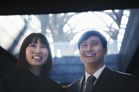 Two business people smiling together, portrait, Beijing の写真素材