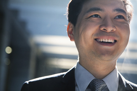Portrait of smiling businessman in a parking garageの写真素材
