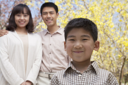Portrait of happy smiling family in the park in springtime, Beijing, Chinaの写真素材