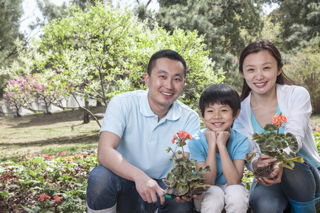 Portrait of family planting flowers.の写真素材