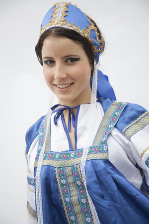 Portrait of young smiling woman in traditional clothing from Russia, studio shotの写真素材
