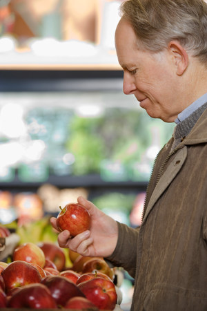 A man holding an appleの写真素材