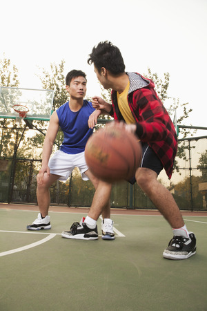Two street basketball players on the basketball courtの写真素材