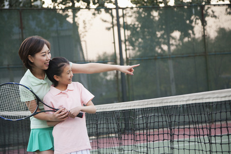 Mother and daughter playing tennis の写真素材