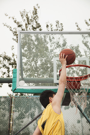 Slam dunk by young man の写真素材