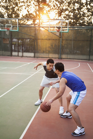 Two street basketball players on the basketball courtの写真素材