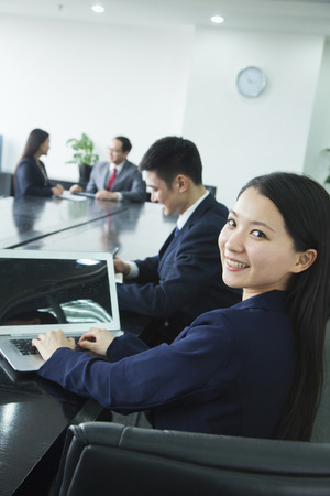 Businesswoman Looking Over Her Shoulder at the Cameraの写真素材
