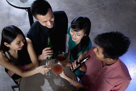A group of friends having drinks in nightclubの写真素材