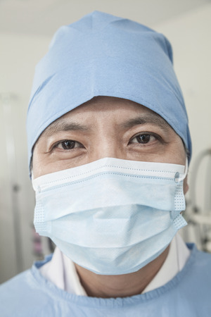Portrait of surgeon with surgical mask and surgical cap in the operating room の写真素材