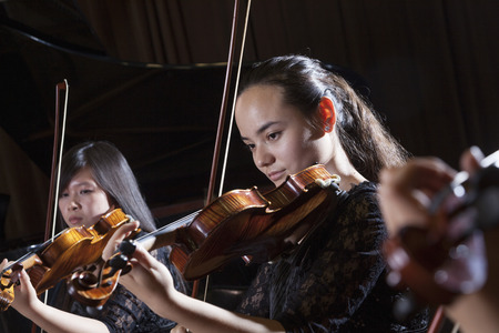 Violinists playing during a performance, head and shouldersの写真素材