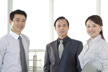 Three Businesspeople Looking at Cameraの写真素材