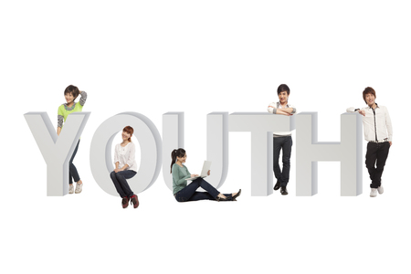 five people sitting in a row smilingの写真素材