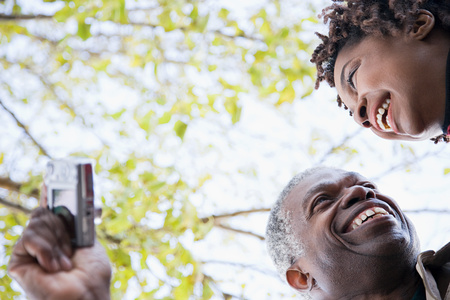 One couple using a cameraの写真素材