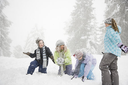 Children playing in the snowの写真素材