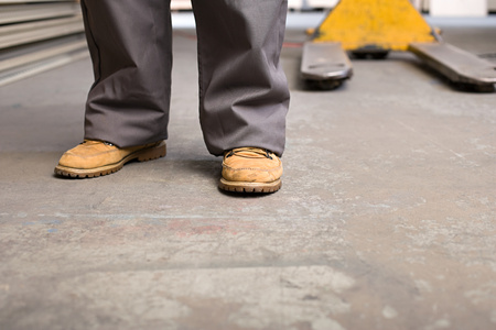 Feet and legs of a person in warehouseの写真素材