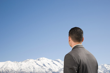 Businessman by mountainsの写真素材