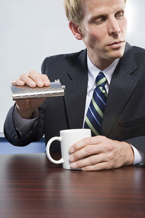 Businessman holding hip flaskの写真素材