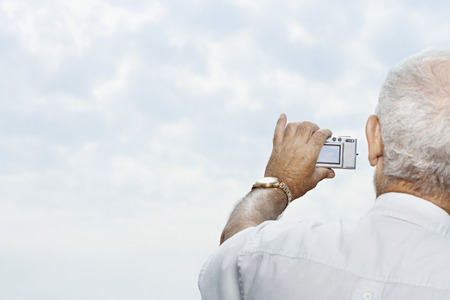 Man taking a picture of the sky