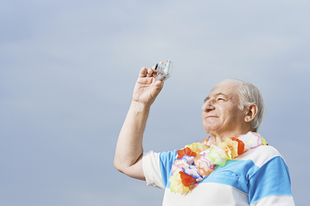 Senior man taking a photographの写真素材