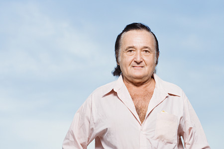 Senior man in a pink shirtの写真素材