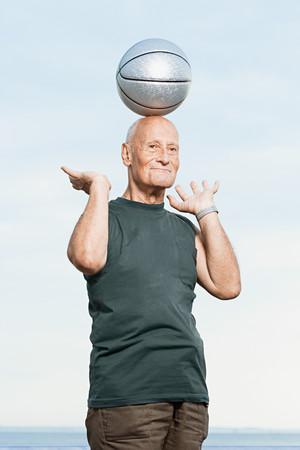 Man balancing basketball on his headの写真素材