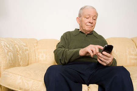 Elderly man using remote controlの写真素材