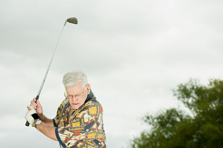 Senior man playing golfの写真素材