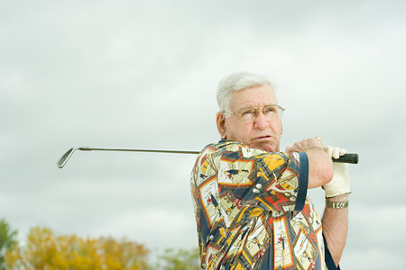 Senior man playing golfの写真素材