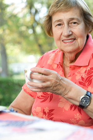Senior adult woman drinking teaの写真素材