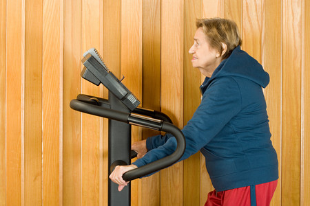 Senior woman walking on a treadmill