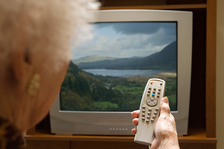 Senior woman watching televisionの写真素材