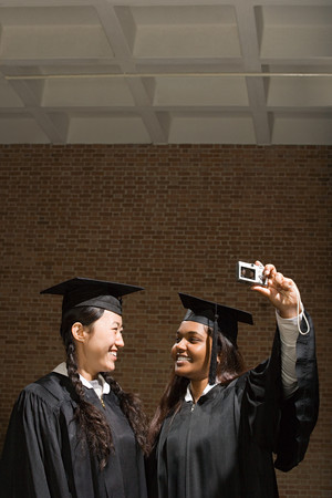 Two female graduates taking a photograph