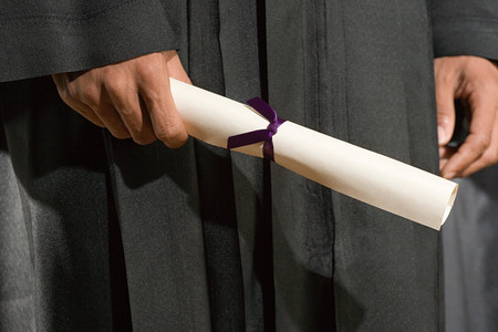 Graduate holding diplomaの写真素材