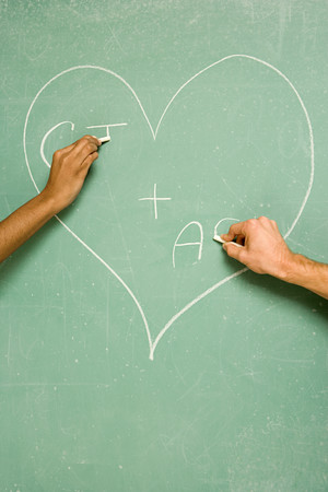 Two students drawing on blackboardの写真素材