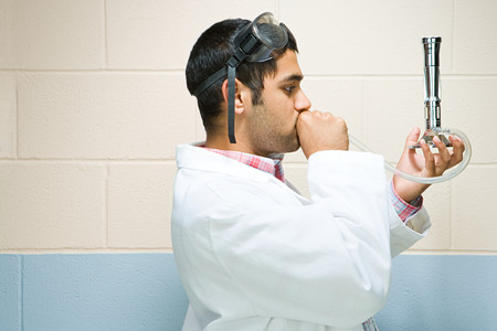 Male student performing an experimentの写真素材