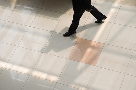 Businessman walking on tiled floor