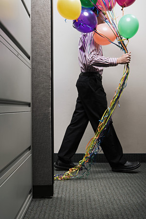 Businessman with a bunch of balloonsの写真素材