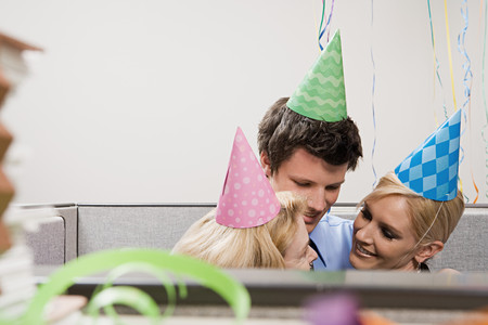Three office workers embracingの写真素材